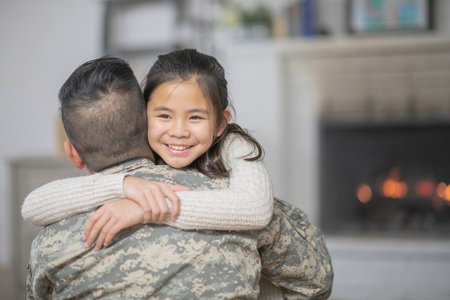 Military Dad Hugging His Young Daughter